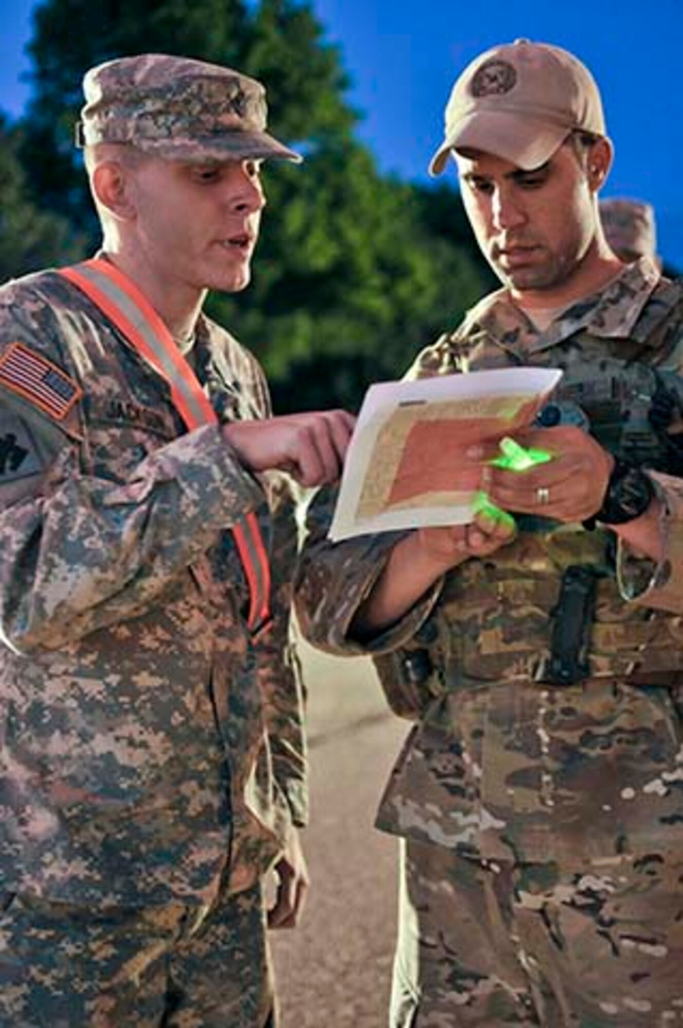 U.S. Army Spc. Justin Jackson, Alpha Company, 179, and U.S. Air Force Tech. Sgt. Larry Mansell, exchange information at a checkpoint during the night in Moore, Okla., May 22, 2013. Checkpoints have been set up all over the city to ensure residents safety and security after the devastating tornado that struck on May 20, 2013. (U.S. Air Force Photo/Staff Sgt. Caroline Hayworth)