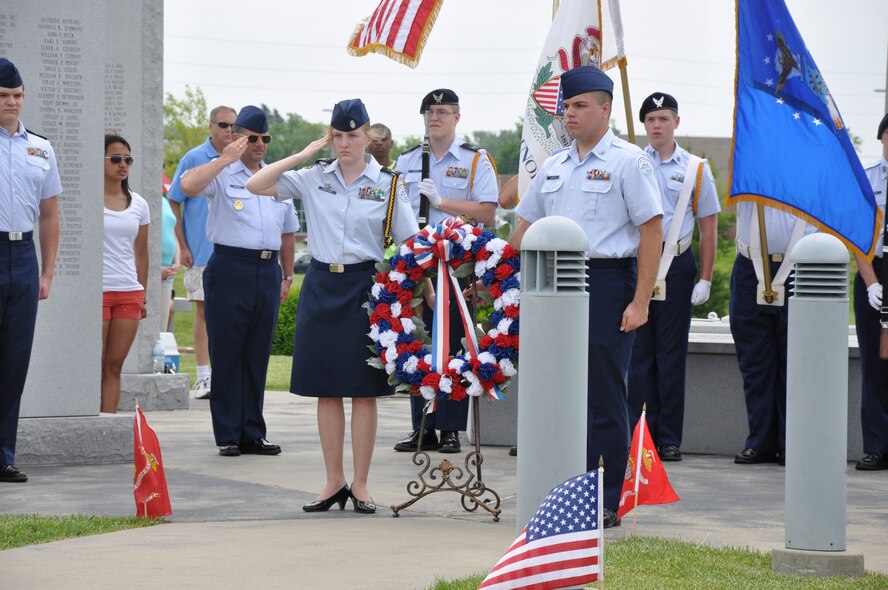 Cadets from O'Fallon Township Air Force Junior ROTC place a wreath at the O'Fallon Veteran's Monument in observance of Memorial Day, O'Fallon, Ill. In addition to the wreath placement, Honor Guard members from Scott Air Force Base performed a Three-Rifle Volley salute to commemorate fallen U.S. service members. (U.S. Air Force photo/Maj. Angela O'Connell)

