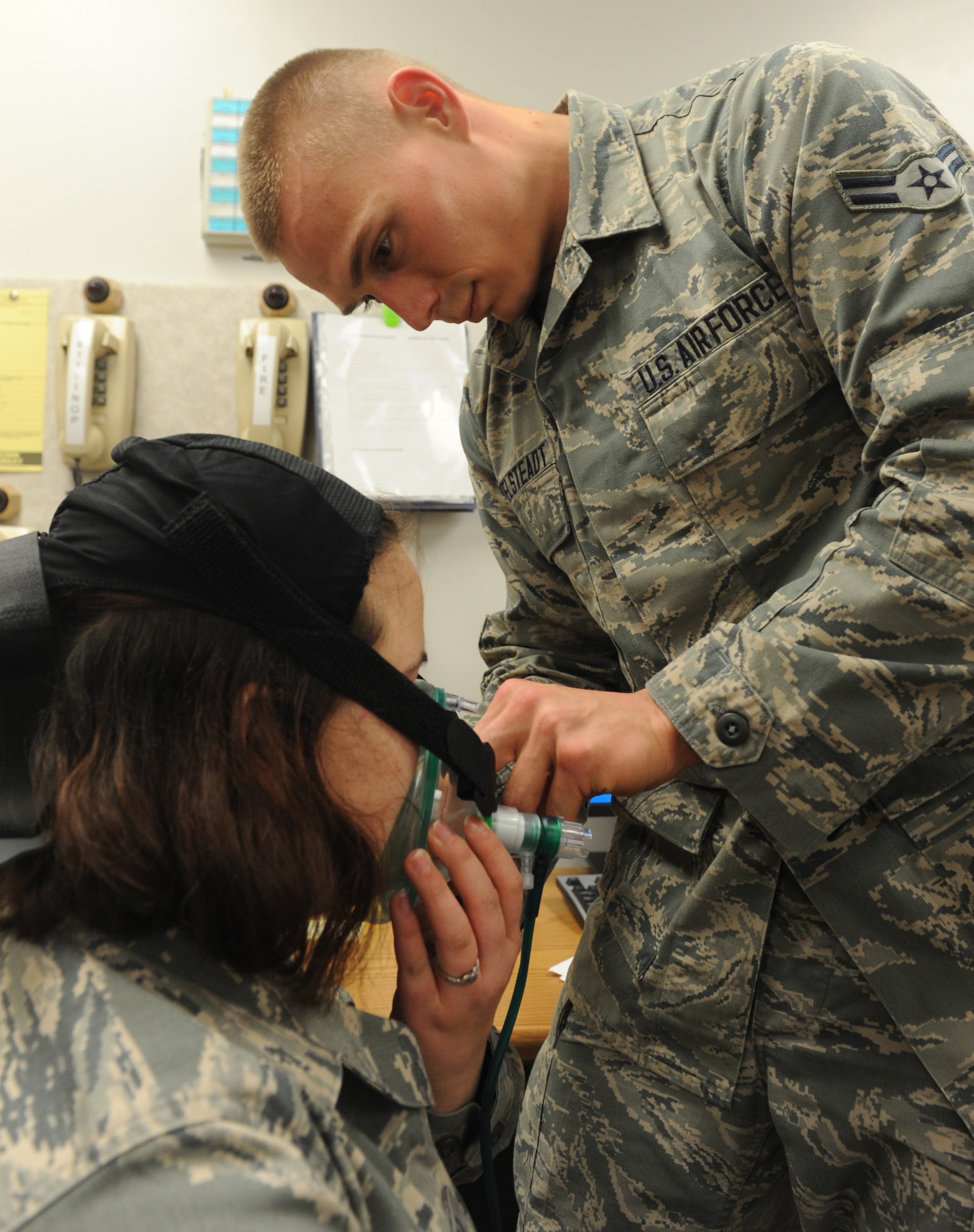 Airman 1st Class Joshua Mittelsteadt, 509th Medical Operations Squadron ambulance services technician, practices putting a breathing apparatus on a patient at Whiteman Air Force Base, Mo., May 23, 2013. Ambulance services technicians attend an 18-week technical training school to learn the facets of the job. (U.S. Air Force photo by Airman 1st Class Bryan Crane/Released)