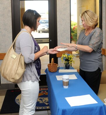 Dana Justice (right) a community readiness technician for the Airman and Family Readiness Center, conducts registration for Heart Link on Beale Air Force Base, Calif., May 30, 2013. Heart Link is a program run by the Airman and Family Readiness Center to help spouses transition into life at Beale. (U.S. Air Force photo by Airman 1st Class Bobby Cummings/Released)