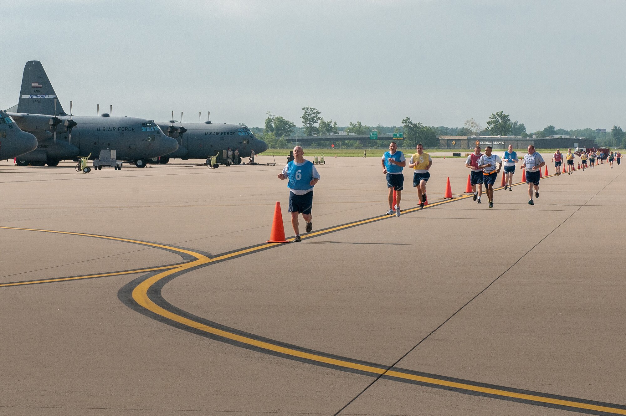 Members of the 123rd Airlift Wing conduct a mass physical fitness test by running on the flight line of the Kentucky Air National Guard Base in Louisville, Ky., on May 19, 2013. The flight line provides a level running surface and minimal turns, which helps boost physical performance. (U.S. Air National Guard photo by Airman Joshua Horton)