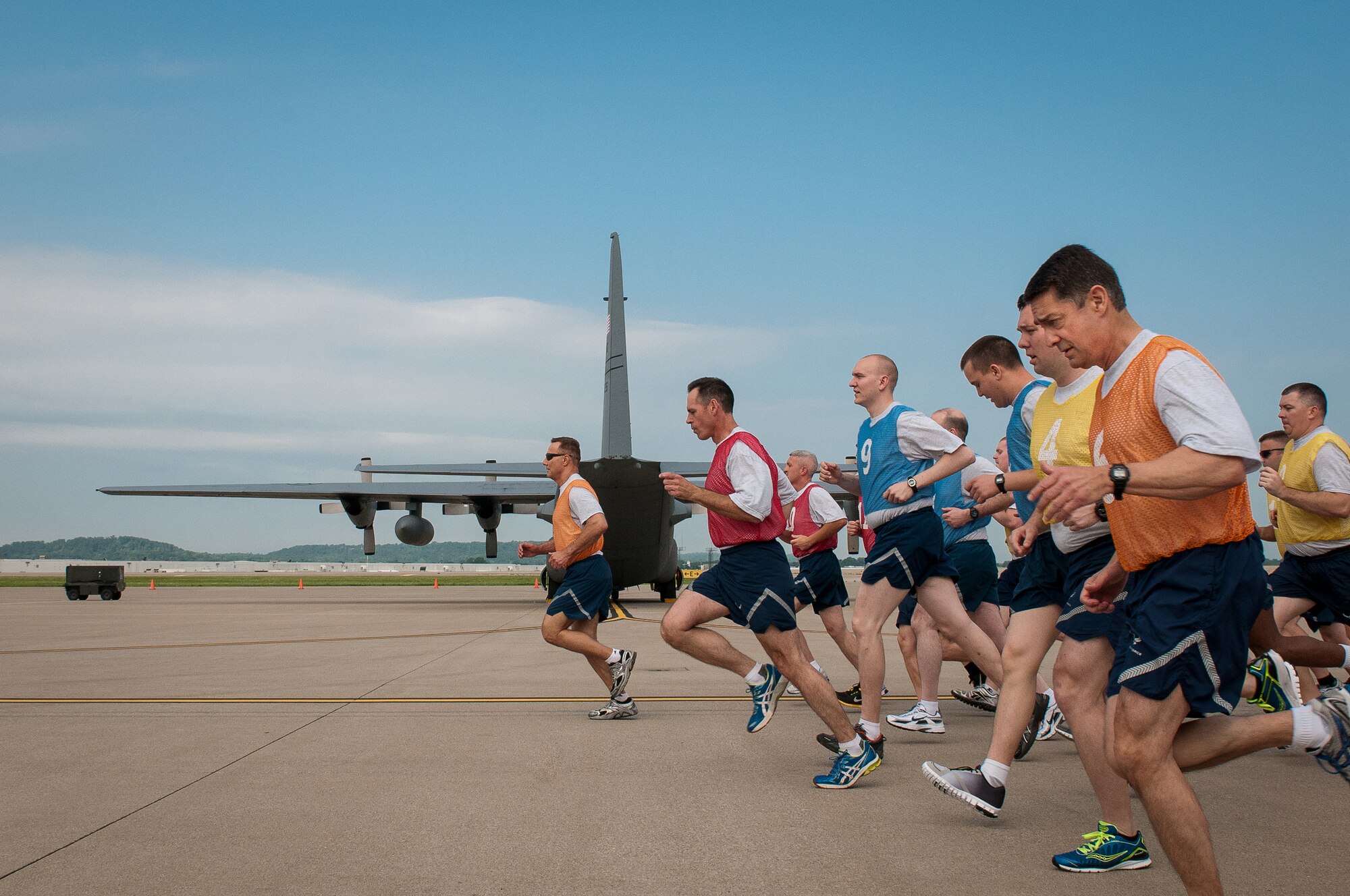Members of the 123rd Airlift Wing conduct a mass physical fitness test by running on the flight line of the Kentucky Air National Guard Base in Louisville, Ky., on May 19, 2013. The mass testing is designed to improve efficiency while giving Airmen the edge to succeed. (U.S. Air National Guard photo by Airman Joshua Horton)