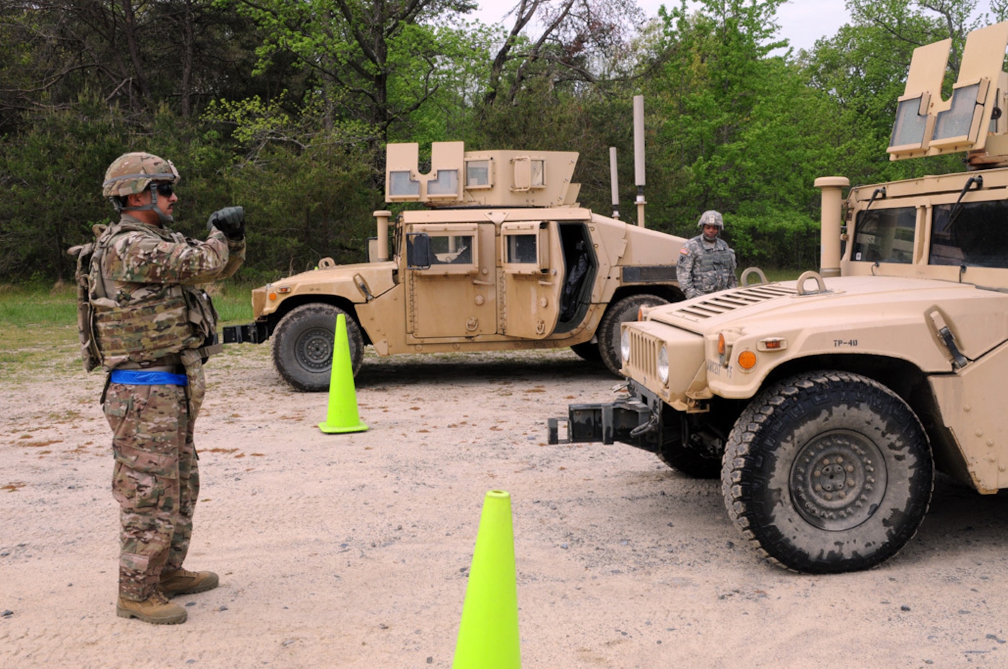 Staff Sgt. Zachariah Lopez assists with ground guiding a Humvee May 15, 2013, at Joint Base McGuire-Dix-Lakehurst, N.J. The drivers’ training course was designed to inform Airmen and Sailors about mission essential equipment usually reserved for Army and Marine forces and the M1151's full capabilities. Lopez is a Corpus Christi, Texas, native and 602nd Training Group broadcaster who is deploying to Afghanistan. (U.S. Army photo by Sgt. David Bolton/Released)