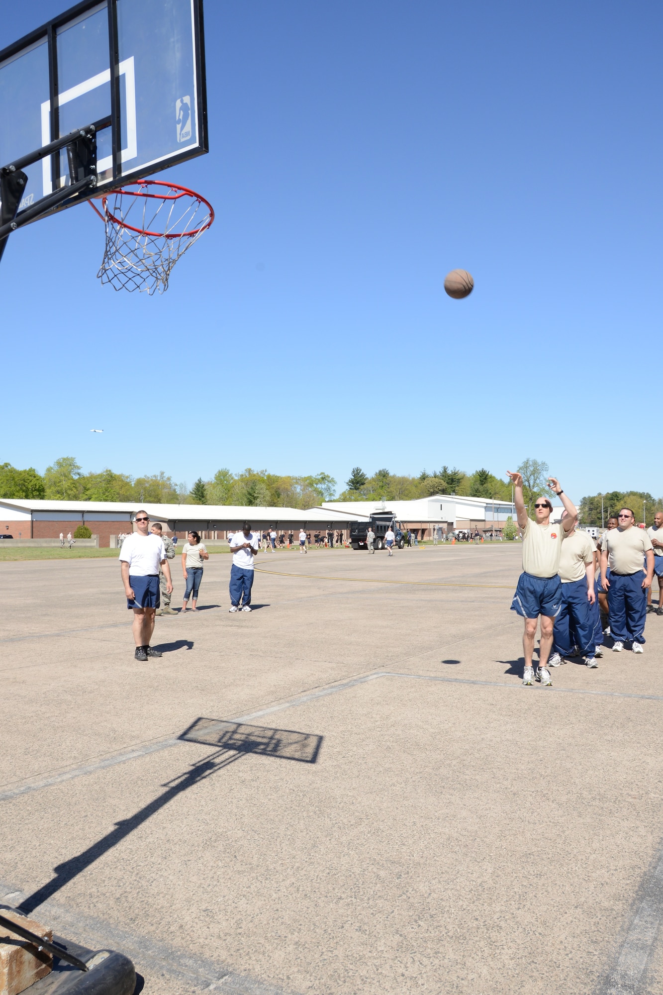 Contestants in the three-point basketball shoot bring their skills to the court (north apron) during the 103rd Airlift Wing’s first ever Warrior Day competition, May 4, 2013, at Bradley Air National Guard Base in East Granby, Conn. The competition consisted of many events from a truck pull and three-point basketball shoot out to a litter carry and a 50-yard “crab –dash”. The competition aimed to promote physical fitness and esprit de corps within the 103rd Airlift Wing. (U.S. Air National Guard photo by Sen-ior Airman Emmanuel Santiago/Released)
