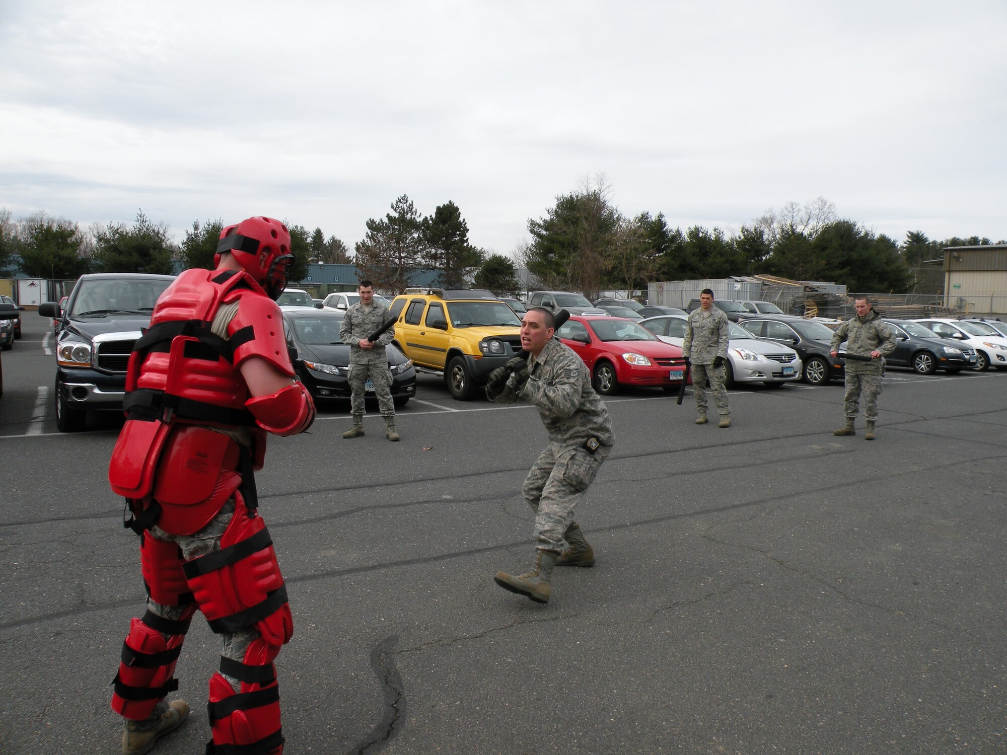 Senior Airman Marvin Perez of the 103rd Security Forces Squadron practices approaching a combative ’hostile’ in a red man suit as part of a training exercise at Bradley Air National Guard Base, East Granby, Conn. in 2013. (Photos courtesy of Tech. Sgt. Jessica Roy)