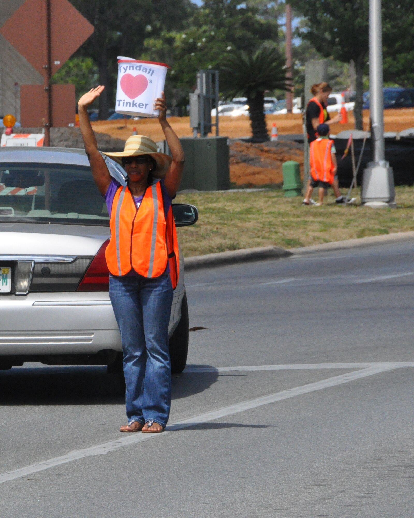 Staff Sgt. Audra Hamilton, 325th Aerospace Medical Squadron NCO in charge of clinic operations, holds her “Tyndall Hearts Tinker” container May 28 as she waves to vehicles driving up to donate funds for Airmen at Tinker Air Force Base, Oklahoma City, Okla., who were affected by the tornadoes that tore through the Oklahoma City area May 19 and 20.  (U.S. Air Force photo by Senior Airman Christopher Reel)