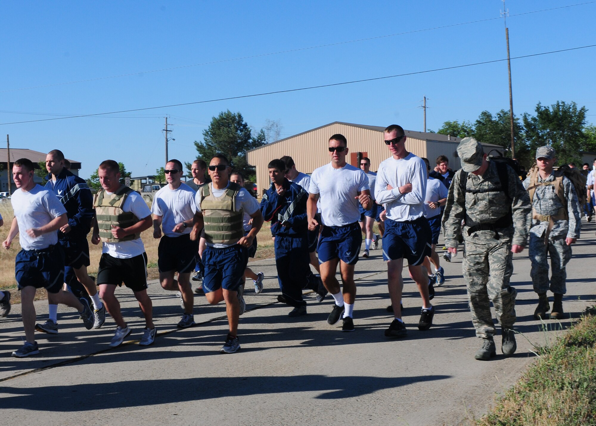 Members of Team Beale run during the Explosive Ordnance Disposal memorial run at Beale Air Force Base, Calif., May 22, 2013. Airmen and their families could run, ruck-march or walk the 4.1 mile course. (U.S. Air Force photo by Senior Airman Allen Pollard/Released)