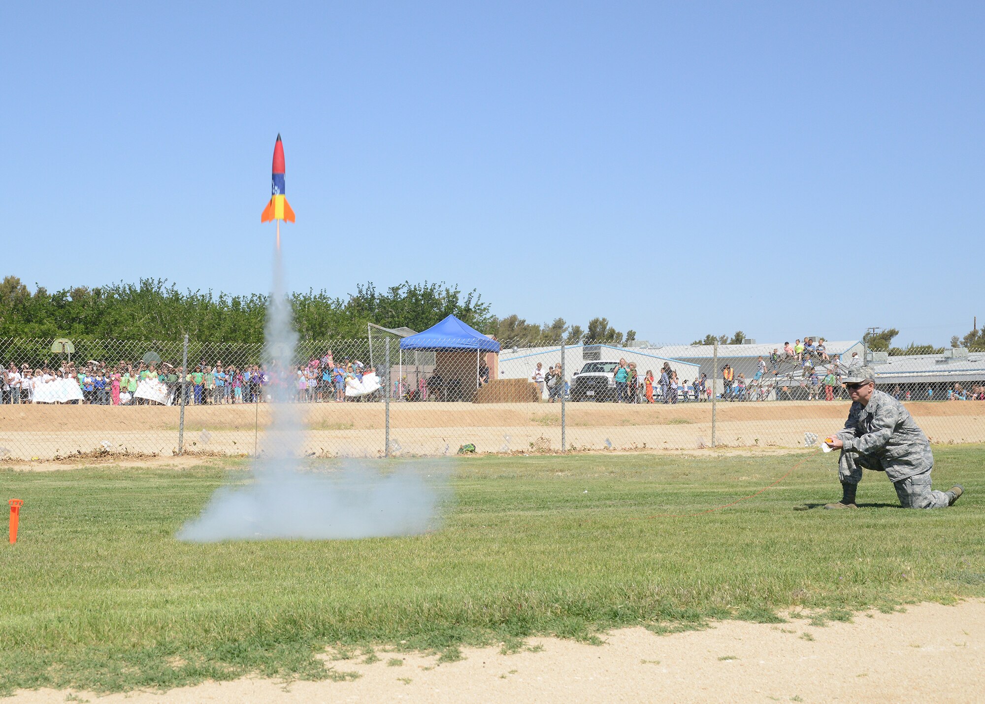 Col. Robert Weaver, 412th Maintenance Group commander, launches the rocket
named "Making Sparks Fly" during the 1st Annual Edwards Intermediate Space
Challenge held at Branch Elementary School May 23.  The rocket was made by a
team of fifth graders. The event was the result of a collaborative effort
between the Muroc School District and the 412th Test Wing.  Twelve teams
consisting of 4th, 5th and 6th graders participated in the challenge. (U.S.
Air Force photo by Kenji Thuloweit)
