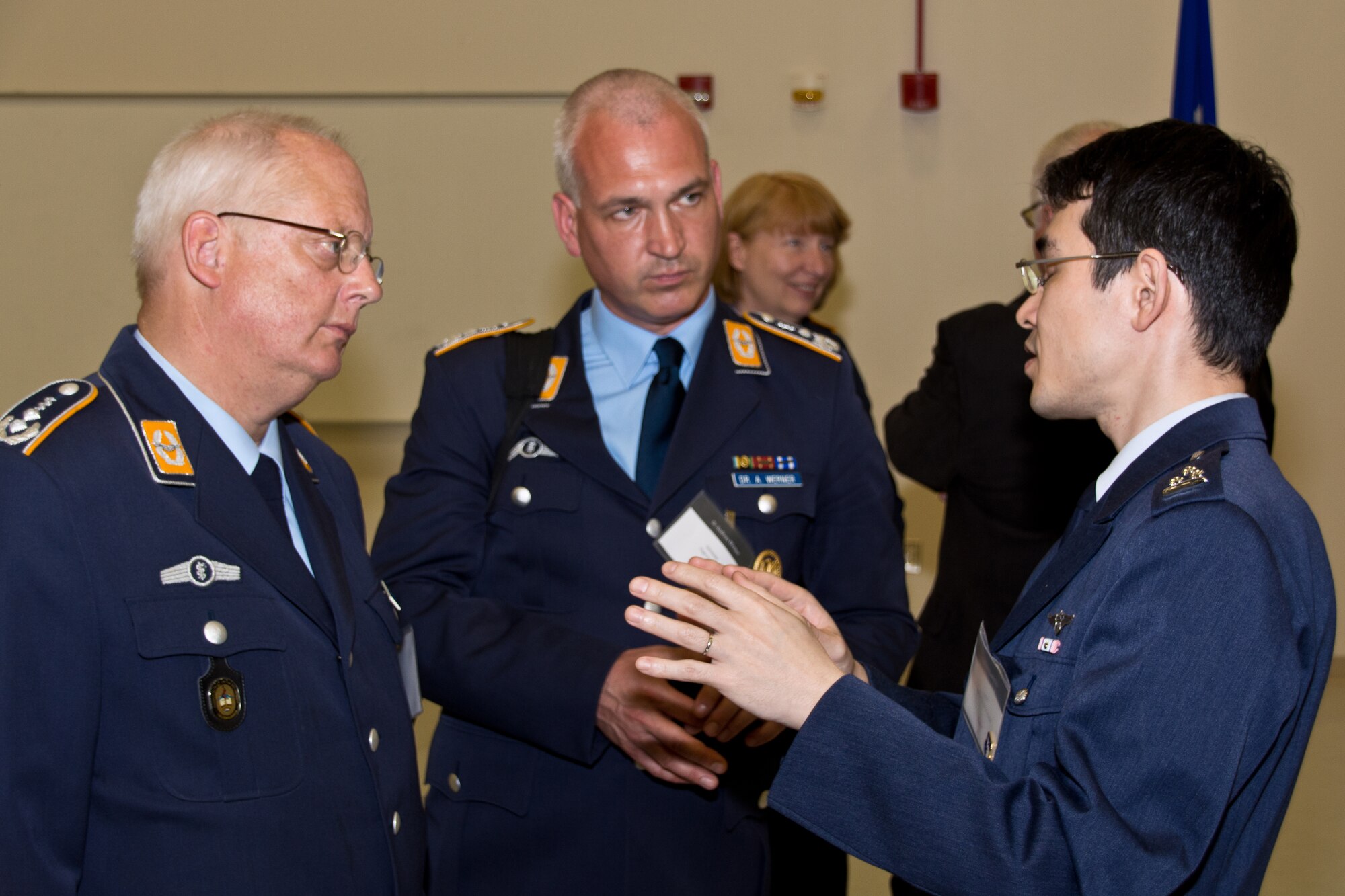 Human Performance Summit attendees from Germany and Singapore discuss current issues in aerospace medicine in the U.S. Air Force School of Aerospace Medicine High Bay.  Photo credit: Mr. Rick Eldridge