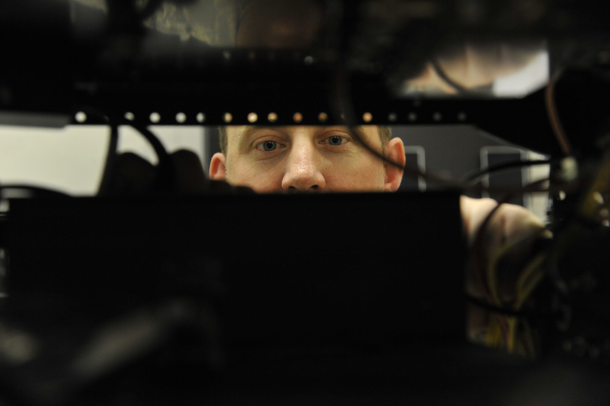 Master Sgt. Michael White, 509th Maintenance Operations Squadron B-2 Spirit computer-aided design manager, wraps adaptable communications suite cables at Whiteman Air Force Base, Mo., May 15, 2013. This wrapping prevents wires on the ACS rack from becoming tangled. (U.S. Air Force photo by Airman 1st Class Keenan Berry/Released)