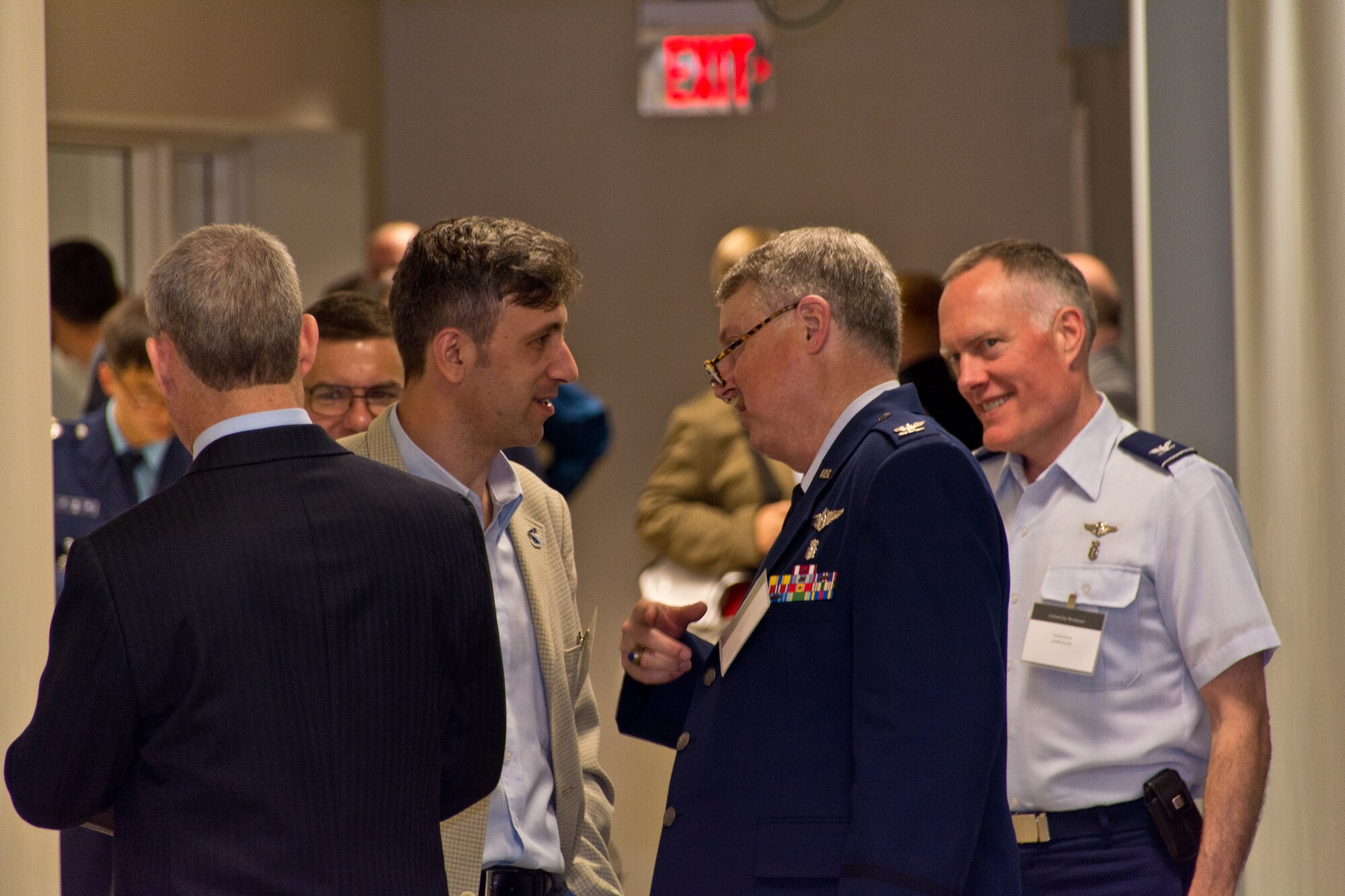 A visitor from Romania talks to Col Hadley Reed of 711 HPW U.S. Air Force School of Aerospace Medicine and Col Jay Neubauer from U.S. Air Forces in Europe Surgeon General’s Office.  Photo credit: Mr. Rick Eldridge