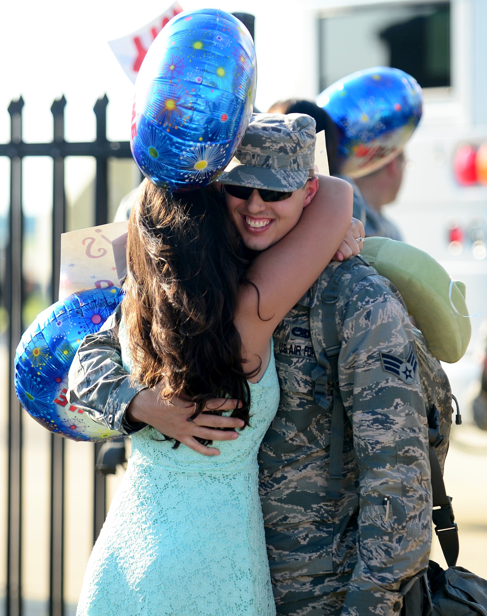 A U.S. Air Force Airman assigned to the 94th Aircraft Maintenance Unit greets his wife upon returning to Langley Air Force Base, Va., May 29, 2013, from a five-month deployment to Kadena Air Base, Japan. Under the direction of the 18th Wing at Kadena, the 94th AMU was evaluated to determine the unit’s ability to meet security obligations in the Asia-Pacific region. (U.S. Air Force photo by Senior Airman Kayla Newman/Released)