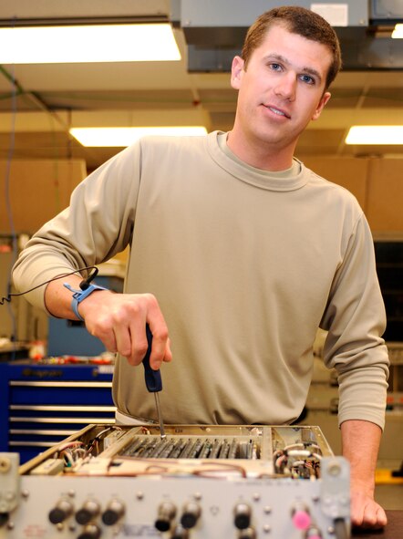 Senior Airman Mike Mound, 28th Maintenance Squadron avionics technician and one of the base's 32 victim advocates, unfastens the circuit cards in a radio frequency source 7 line replaceable unit with a Wedgelock fastener on Ellsworth Air Force Base, S.D., May 21, 2013. Mound, like all victim advocates, has completed 40 hours of initial training - including a brief from Ellsworth's Office of Special Investigations and a tour of a local hospital - giving him an enhanced perspective on a victim's recovery process. (U.S. Air Force photo by Airman 1st Class Ashley J. Thum/Released)
