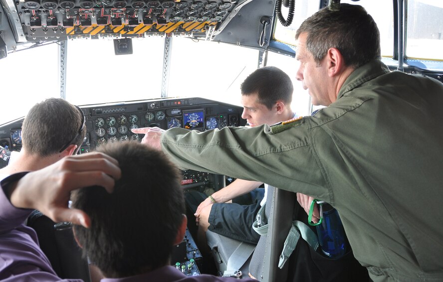 PETERSON AIR FORCE BASE, Colo.  -- Air Force Reservist and C-130 pilot Lt. Col. Brad Ross explains flight deck instruments to University of Colorado Reserve Officer Training Corps cadets during a tour May 22 here.  Besides touring the C-130, the college freshmen and sophomore students listened to 302nd Airlift Wing command and Modular Airborne Fire Fighting briefs. The expected Department of Defense imposed civilian furloughs could have an effect on future 302nd Airlift Wing tours. (U.S. Air Force photo/Master Sgt. Daniel Butterfield)