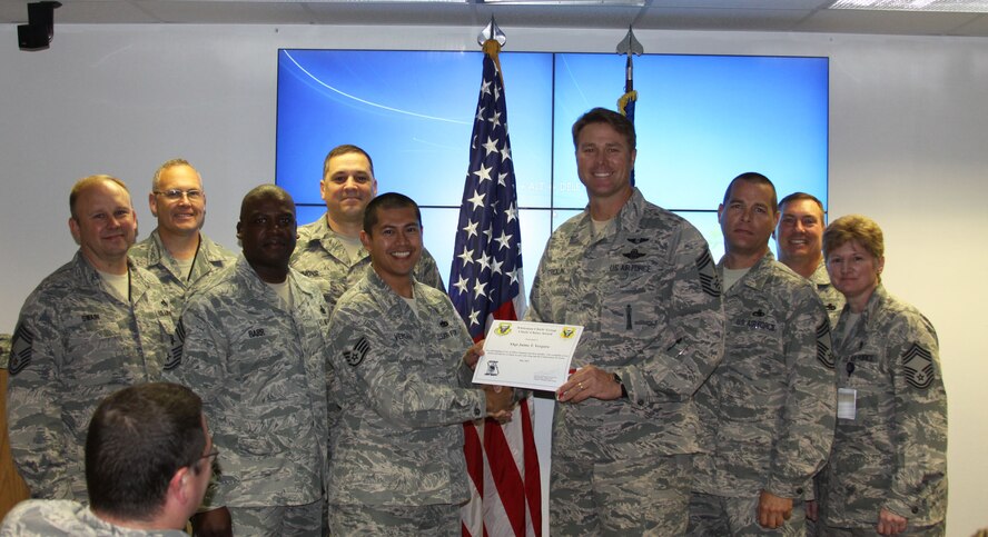 Staff Sgt. Jaime Vergara, 509th Medical Support Squadron, accepts the Chiefs’ Choice Award from Chief Master Sgt. John Stricklin, 20th Reconnaissance Squadron chief enlisted manager, May 23, 2013, at Whiteman Air Force Base, Mo.  Vergara earned the award for kick-starting the Asian-Pacific American Heritage Committee, which had been dormant at Whiteman for the past three years. For the month’s festivities, he organized food tasting, martial arts demonstrations and cultural dances. (U.S. Air Force photo by Senior Airman Ariel Nakmanee/Released)