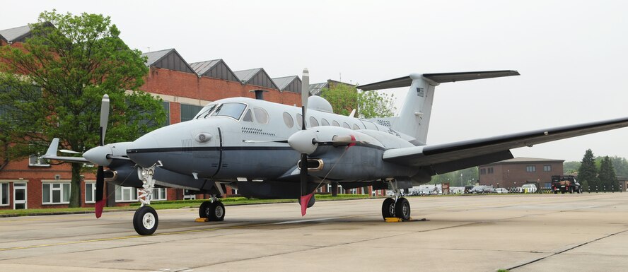 An MC-12W sits on the flightline May 29, 2013, at RAF Mildenhall, England, during a rest-stop on its way home to the United States. The aircraft, a medium-to-low-altitude, twin-engine turboprop was on a ferry flight for an upgrade. The primary mission of the MC-12W is providing intelligence, surveillance and reconnaissance support directly to ground forces. Transient aircraft frequently stop at RAF Mildenhall for crew rest and to refuel before continuing on to complete their mission. (U.S. Air Force photo by Karen Abeyasekere/Released)