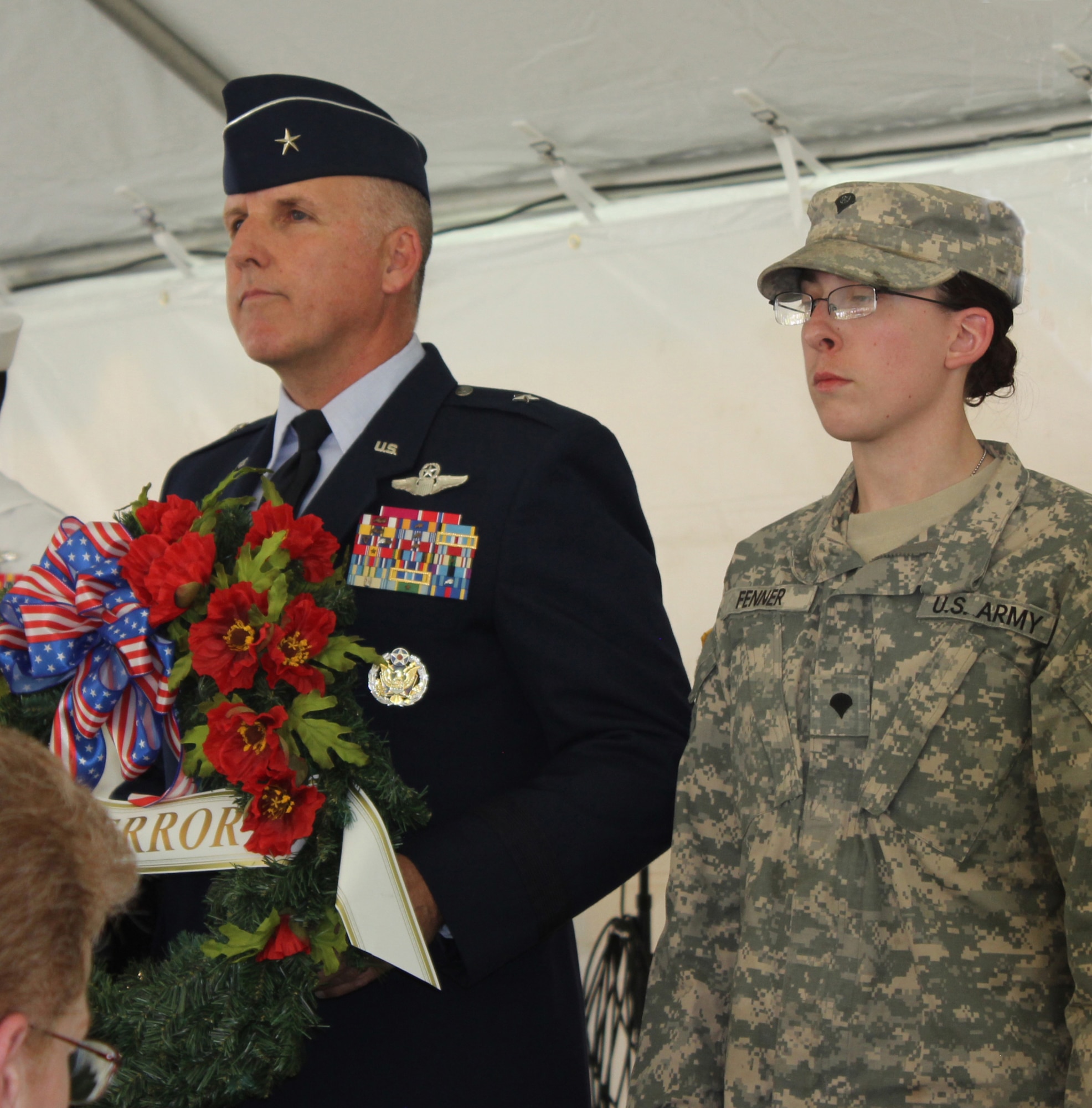 Brig. Gen. Jay Flournoy, commander of the Air Reserve Personnel Center, escorts Army Specialist Allison Fenner to present a wreath in remembrance of military members from the War on Terror as part of the Veterans Memorial Day Tribute in Denver, May 25. (U.S. Air Force photo/Cindy Dewey) 
