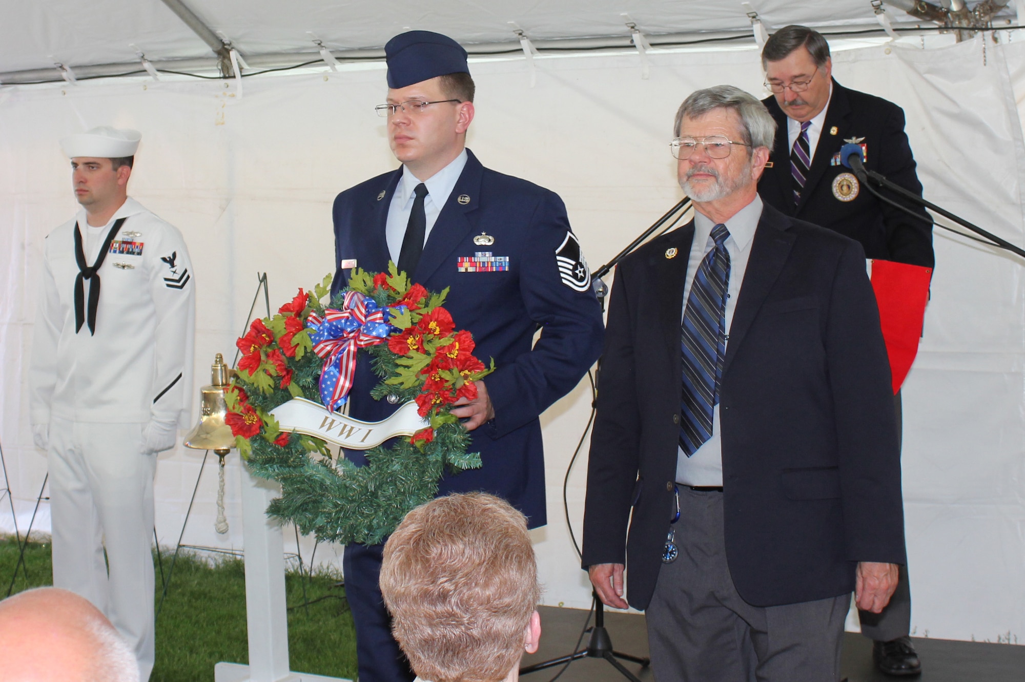 Master Sgt. Justin Jump escorts Air Force Sgt. William Russell to present a wreath in remembrance of military members from World War I as part of the Veterans Memorial Day Tribute in Denver, May 25. (U.S. Air Force photo/Cindy Dewey) 