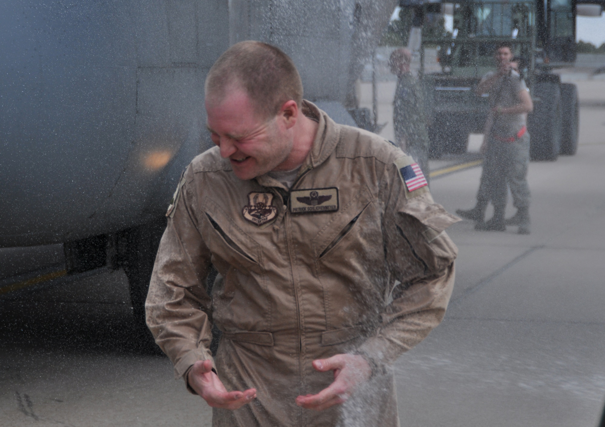 Lt. Col. Patrick Schlichenmeyer, 52nd Airlift Squadron commander, receives a wet welcome after his redeployment from Southwest Asia and final flight with the Air Force Reserve Command’s 302nd Airlift Wing May 16 here. Lt. Col. Jason Terry will replace Schlichenmeyer as the commander of the active duty associate squadron during a change of command ceremony May 31st. (U.S. Air Force photo/Master Sgt. Daniel Butterfield)