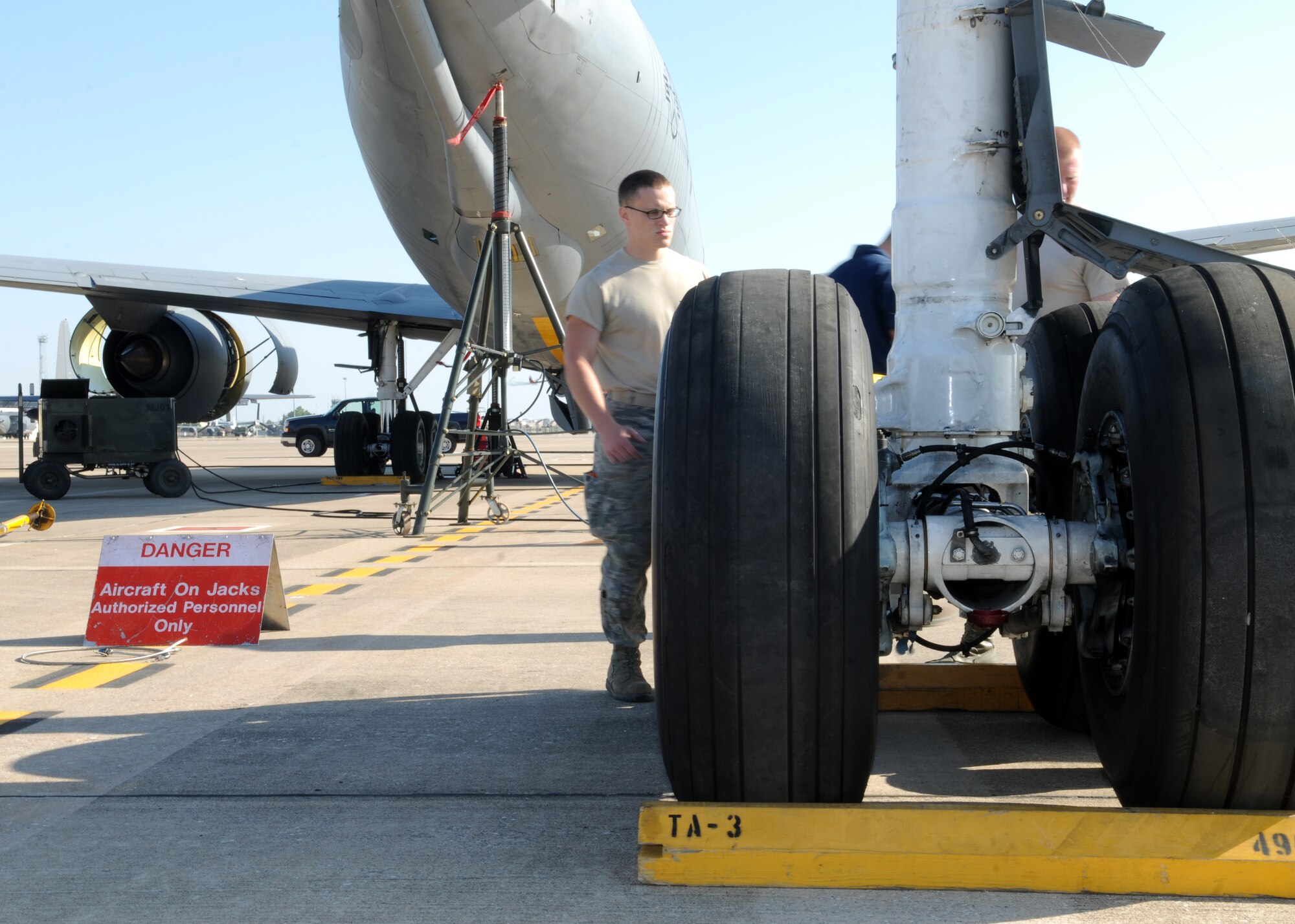 Nathanael Glass, 100th Logistics Readiness Squadron, helps block off the right main-landing gear of a KC-135R May 24, 2013, at Moron Air Base, Spain. Maintenance crews removed the gear to repack the strut, which had a break in the seal. The strut is a sealed system and provides cushion via pressure created by hydraulic fluid compressing air when the aircraft lands. (U.S. Air Force photo by 1st Lt. Christopher Mesnard/Released)