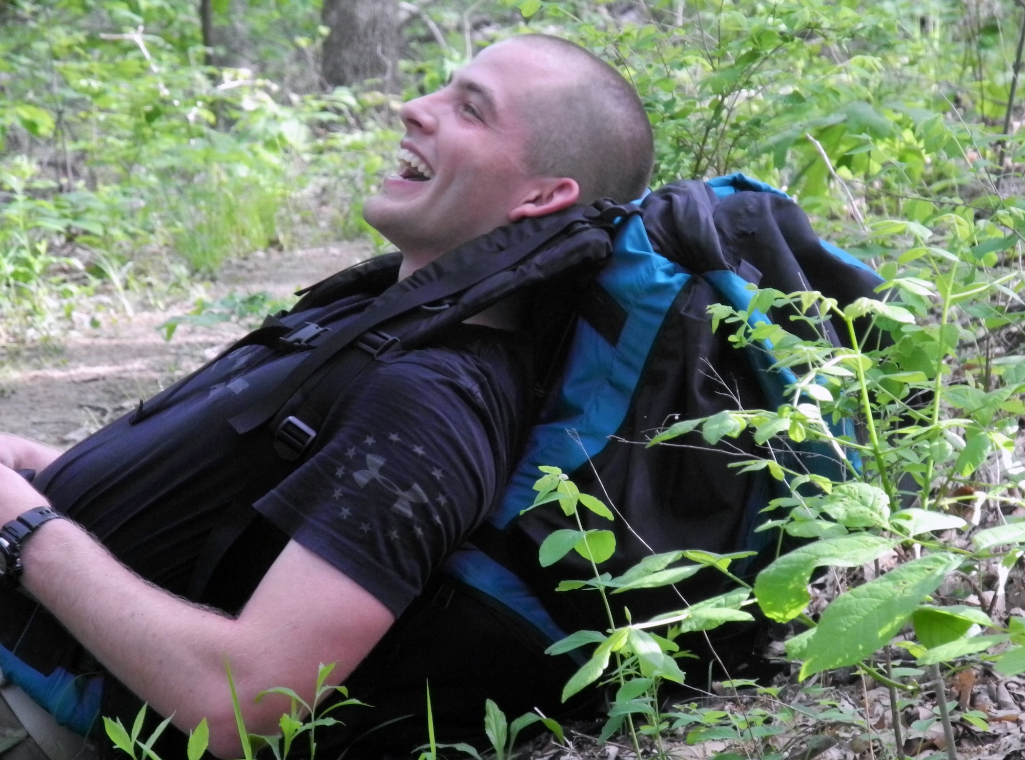Airman 1st Class Austin Meadows, from the 509th Contracting Squadron at Whiteman Air Force Base, Mo., takes a break during a six-mile hike through nearby Knob Noster State Park, May 18, 2013. Meadows organized this march to raise funds for the Wounded Warrior Project. (U.S. Air Force photo by Airman 1st Class Jennifer Boll/Released)