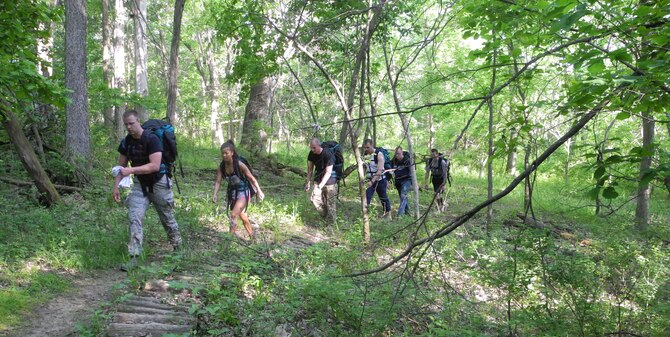 Airmen from the 509th Contracting Squadron at Whiteman Air Force Base, Mo., hike through nearby Knob Noster State Park May 18, 2013. The team lugged a total of 450 pounds during the three-hour hike to raise funds for the Wounded Warrior Project. (U.S. Air Force photo by Airman 1st Class Jennifer Boll/Released)

