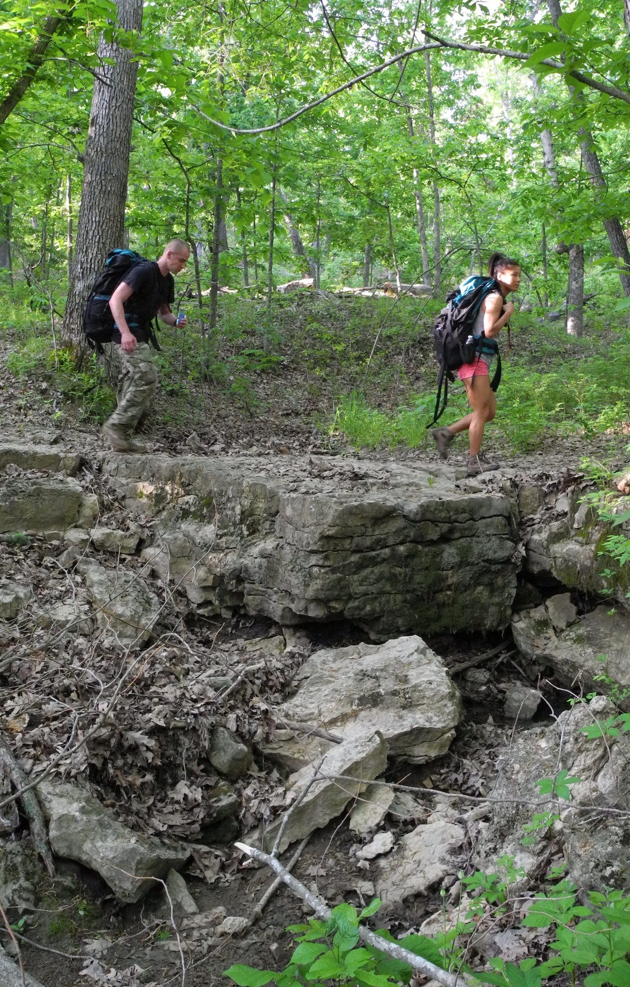 Airman 1st Class Austin Meadows, left, and 2nd Lt. Alicia Fleshman, both from the 509th Contracting Squadron at Whiteman Air Force Base, Mo., hike through nearby Knob Noster State Park, May 18, 2013. Meadows said he believes strongly in the Wounded Warrior Project mission to honor and empower wounded warriors. (U.S. Air Force photo by Airman 1st Class Jennifer Boll/Released)