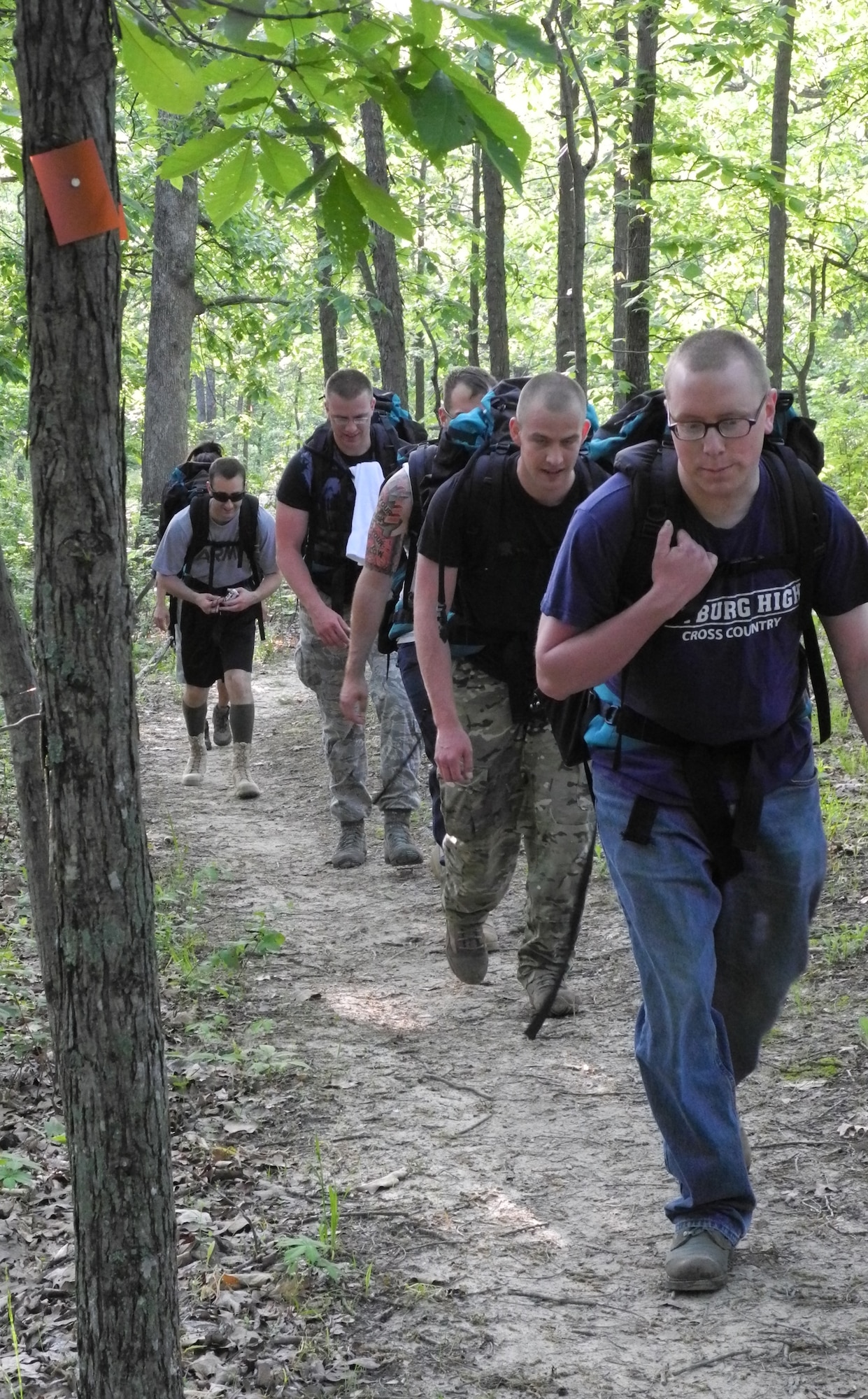 A group of Airmen from the 509th Contracting Squadron ruck through Knob Noster State Park near Whiteman Air Force Base, Mo., May 18, 2013. The six-mile hike was done to raise funds for the Wounded Warrior Project, which provides unique programs and services to injured veterans. (U.S. Air Force photo by Airman 1st Class Jennifer Boll/Released)