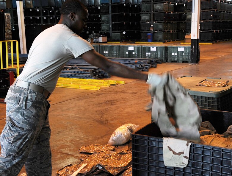 Senior Airmen Melvin Ashley, 2nd Logistics Readiness Squadron individual protective equipment, sorts through chemical protective gear at Barksdale Air Force Base, La., May 29, 2013. IPE Airmen at the 2nd LRS mobility section are responsible for more than 10,500 pieces of equipment Barksdale Airmen use while on a temporary duty assignments or deployments. (U.S. Air Force photo/Staff Sgt. Jason McCasland)