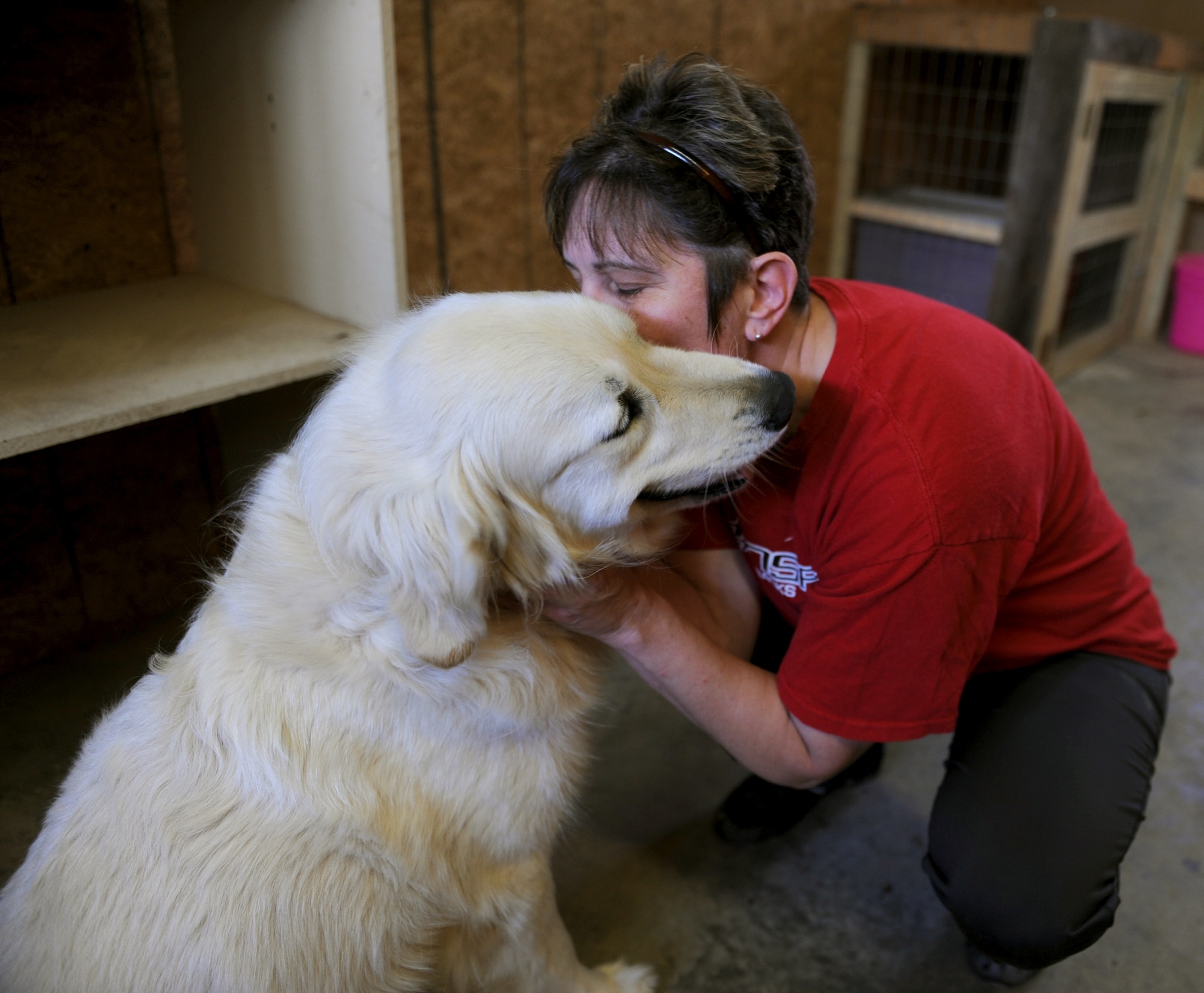 Senior Master Sgt. Melissa Spruling, 19th Military Personnel Section superintendent, kisses one of her rescue animals May 7, 2013, at her home. Spurling runs a shelter out of her home, which currently shelters 16 dogs and 35 cats. (U.S. Air Force photo by Airman 1st Class Scott Poe) 