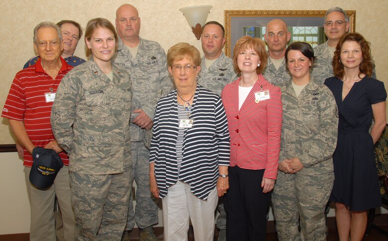 Airmen with 178th Logistics Readiness Squadron, Ohio National Guard, right, pose with employees of Hospice of the Miami Valley, May 18, 2013, at Eaglewood Village, Springfield, Ohio.  The Airmen volunteered as part of the 178th Logistics Readiness Squadron support of a veteran recognition ceremony taking place at the assisted living facility. 