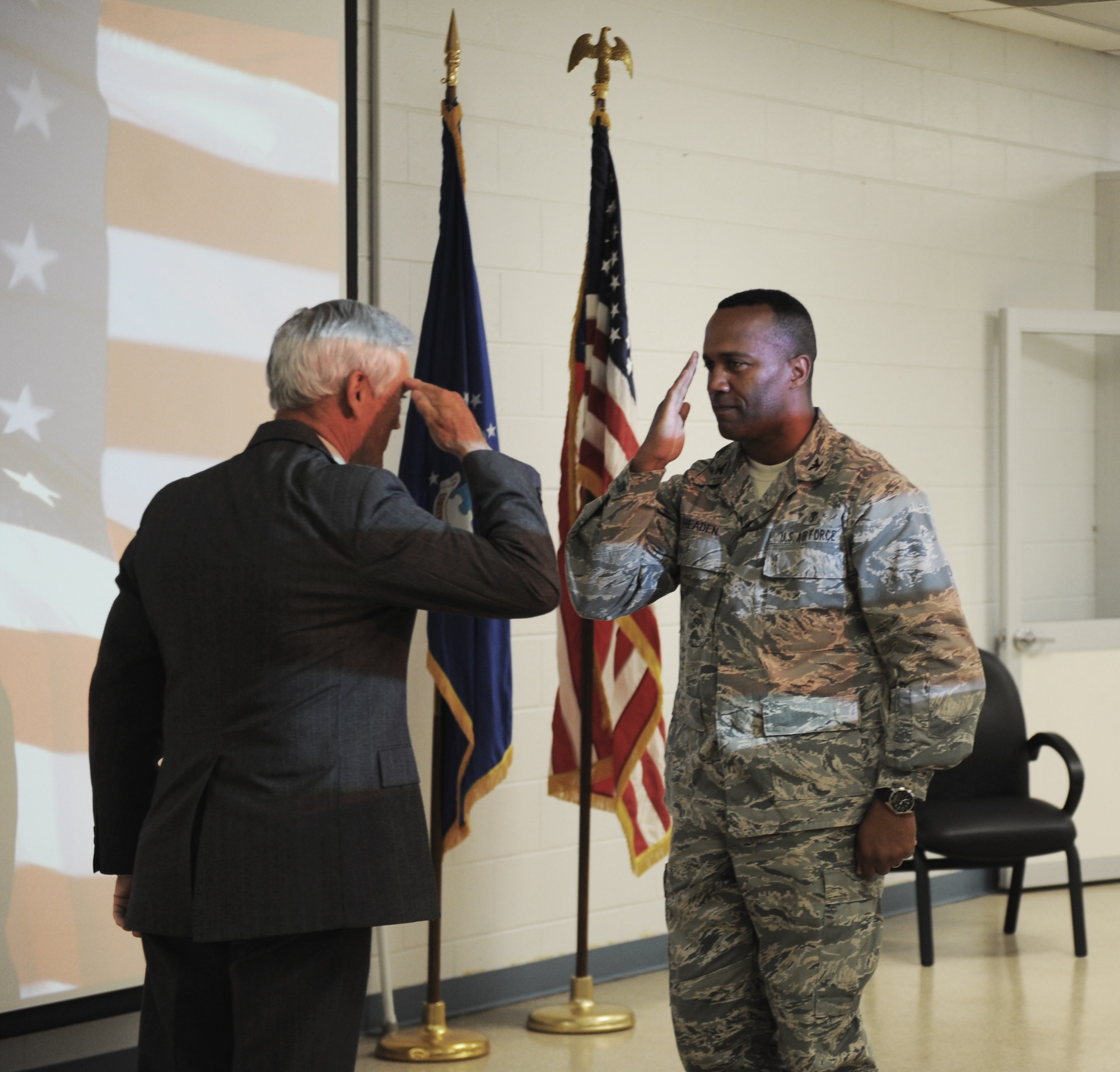 U.S. Air Force Col. Alvis Headen, 23d Medical Group commander, renders a salute to retired Lt. Col. Barry Bridger at Moody Air Force Base, Ga., May 17, 2013. Bridger shared his story with the 23d MDG about his experiences as a prisoner of war during the Vietnam War. (U.S. Air Force photo by Staff Sgt. Melissa K. Mekpongsatorn/Released)