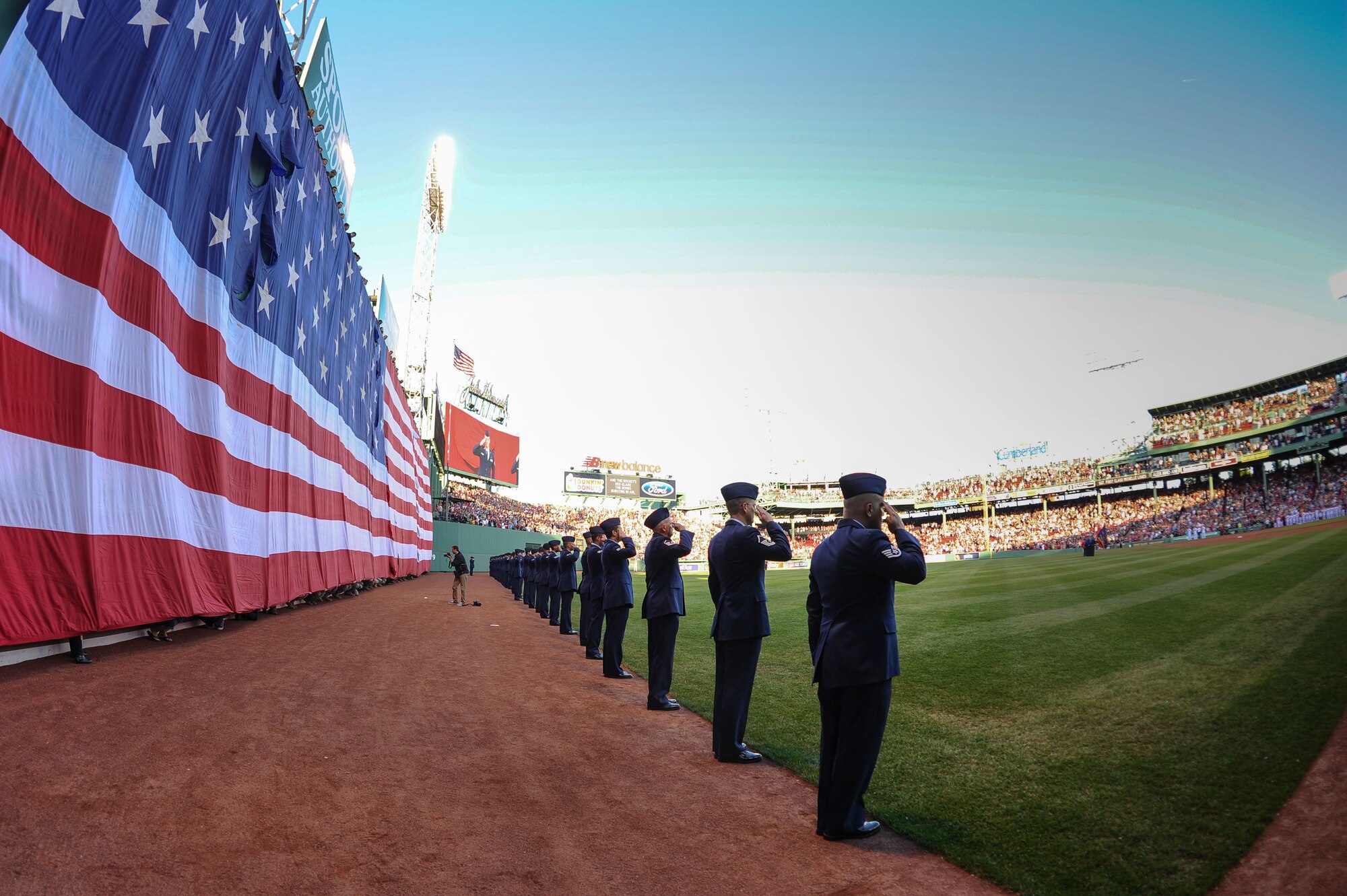BOSTON – Airmen salute in front of an American flag draped over the “green monster” during the national anthem before a Red Sox game at Fenway Park May 27. The flag detail was part of the Memorial Day ceremony held prior to the game that included Airmen from Hanscom, as well as Air National Guard from New Hampshire and Vermont. (U.S. Air Force photo by Mark Herlihy)