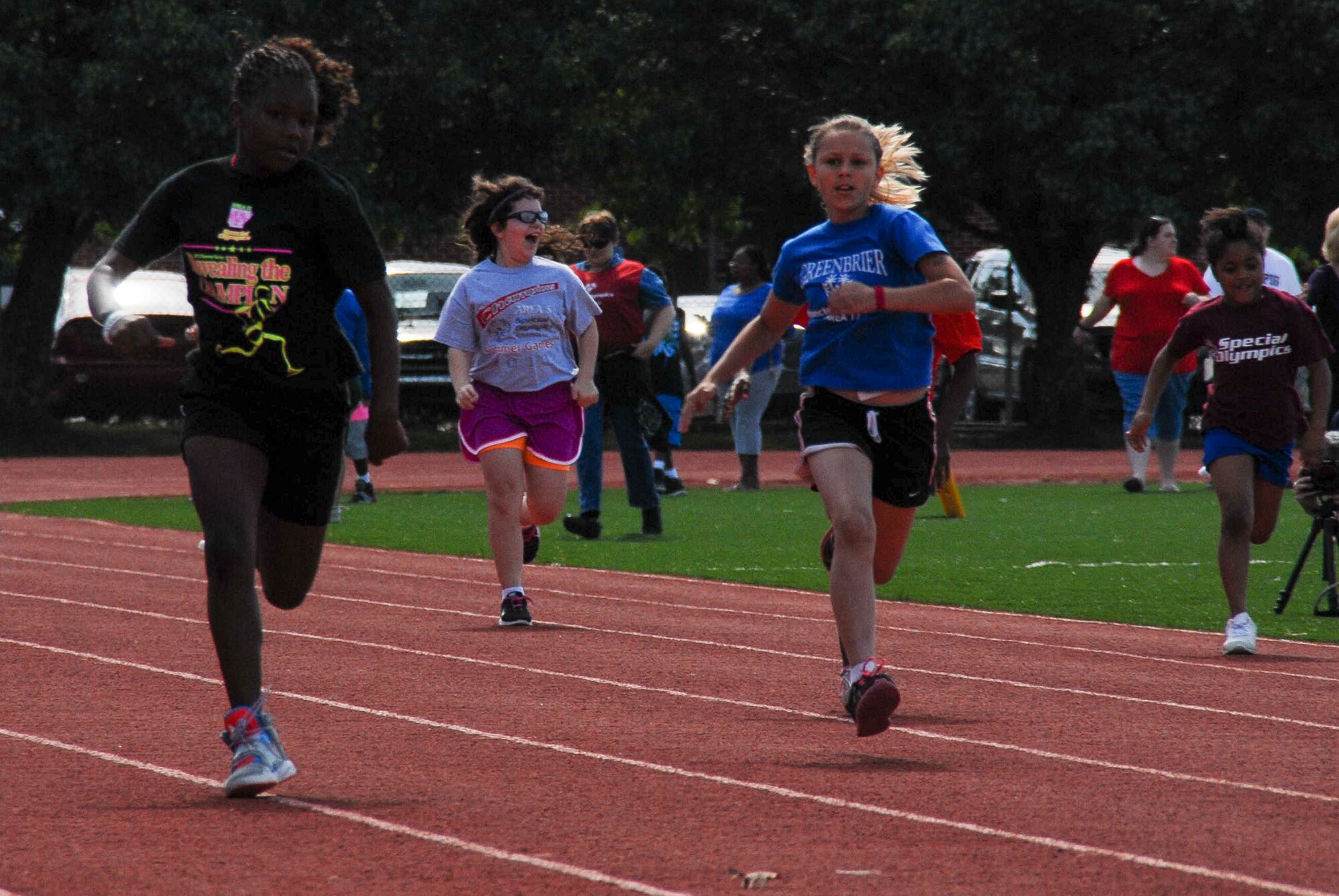 Catherine Hayes, daughter of Michael and Stephanie Hayes, runs in the 100 meter dash May 25, 2013, at the 2013 Arkansas Summer Special Olympics, at Harding University Football Stadium in Searcy, Ark. Catherine, diagnosed with autism, competed in two events at the Olympics. (U.S. Air Force photo by Staff Sgt. Jacob Barreiro)