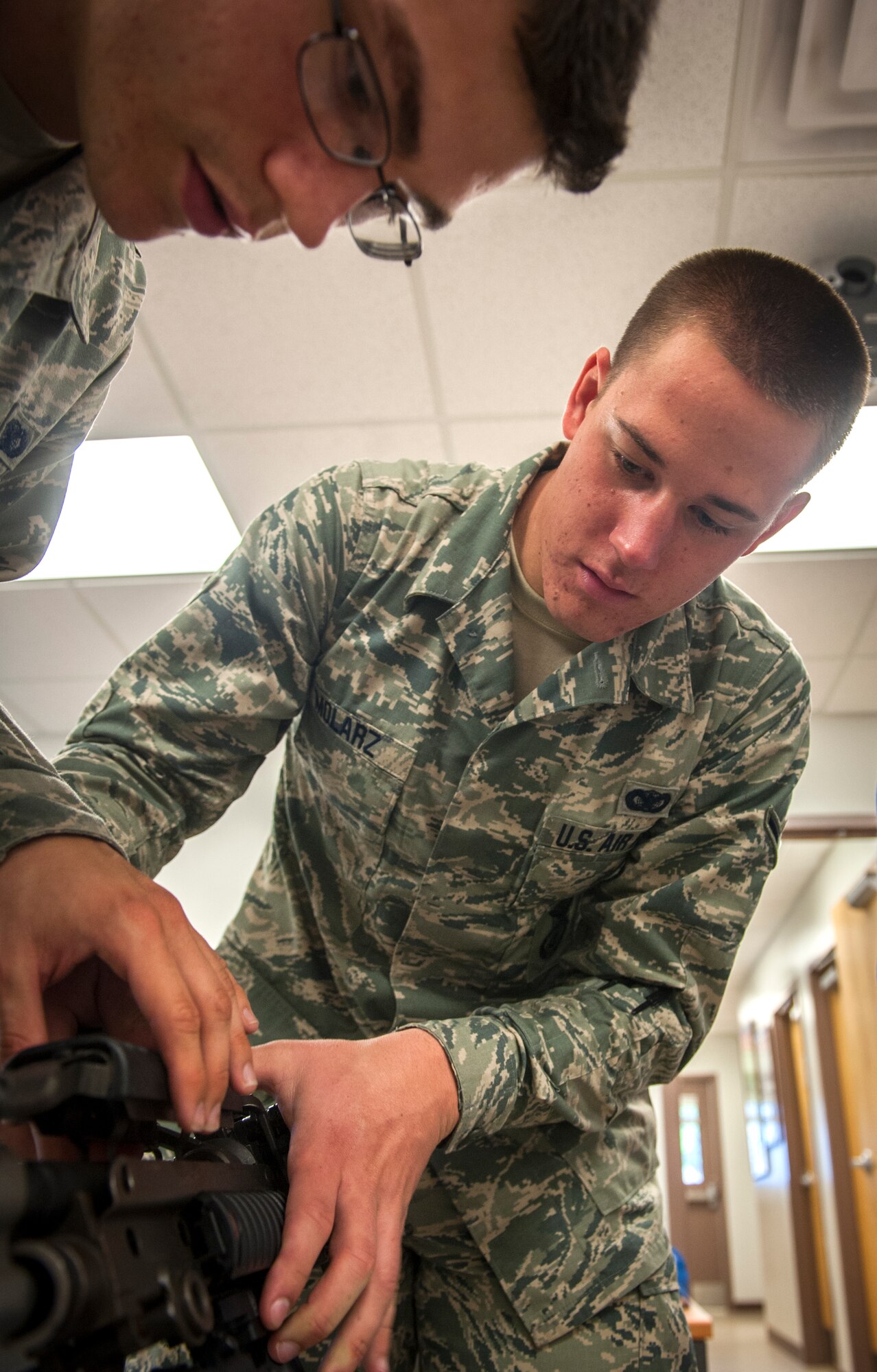 U.S. Air Force Airman Justin Molarz, 822nd Base Defense Squadron fireteam member, participates in a weapons puzzle scenario for the 2013 Safeside Reunion at Moody Air Force Base, Ga., May 18, 2013. The weapons puzzle was a timed competition that required the teams to assemble a variety of modern firearms used by the 820th Base Defense Group. (U.S. Air Force photo by Senior Airman Jarrod Grammel/Released)
