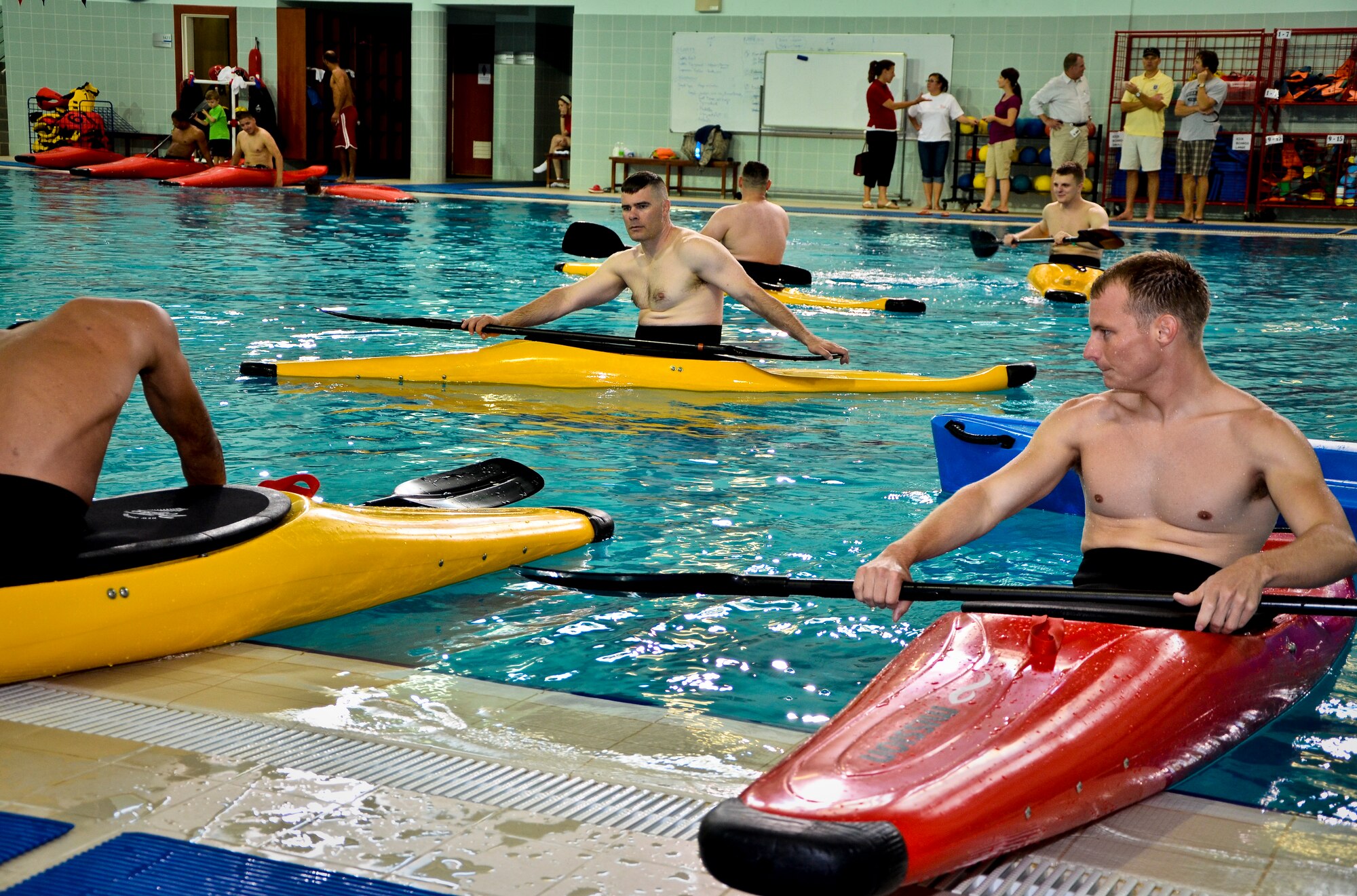 Servicemembers from the 379th Air Expeditionary Wing learn how to kayak at a local school’s annual military appreciation day, May 25, 2013, in Southwest Asia. This annual military appreciation day was for servicemembers to get away from the wartime operational environment of the base and spend some time relaxing. (U.S. Air Force photo/Senior Airman Benjamin Stratton)