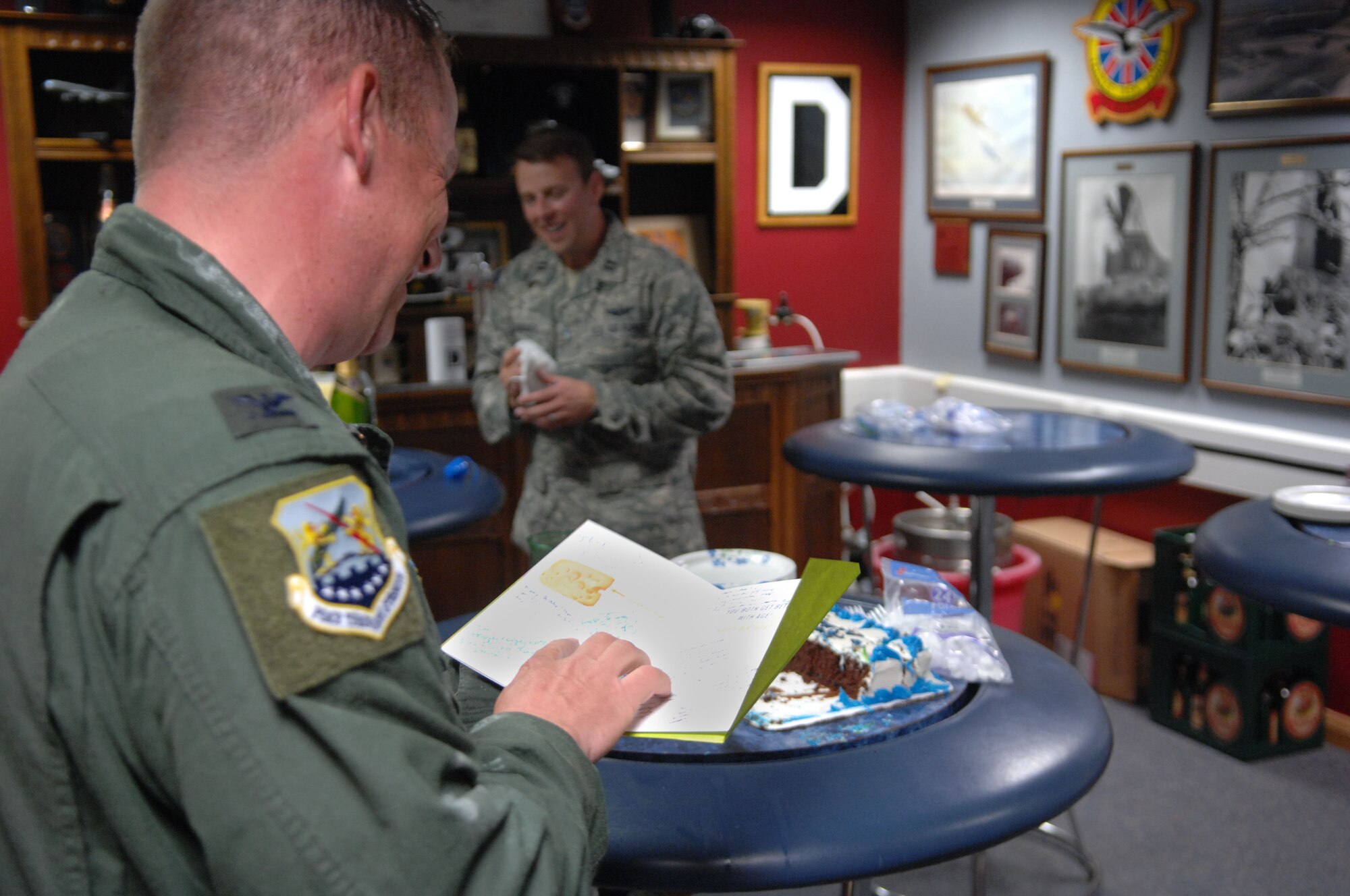 Col. Kyle Voigt, 100th Air Refueling Wing vice commander, reads a card signed by Team Mildenhall members following his fini flight May 29, 2013, at RAF Mildenhall, England. Voigt has been the vice commander of the 100th ARW since July 2011. The flight, a routine training refueling mission with the 31st Fighter Wing, commemorated Voigt’s time at RAF Mildenhall. (U.S. Air Force photo by Airman 1st Class Dillon Johnston/Released)