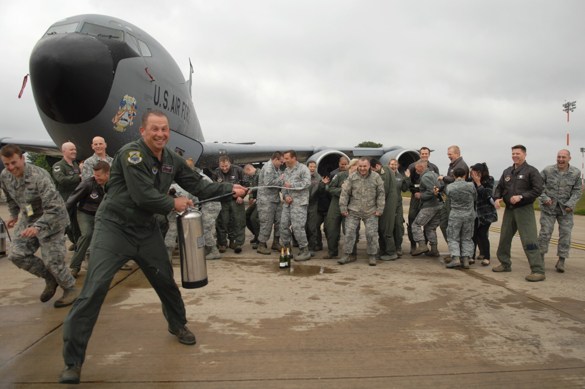 Col. Kyle Voigt, 100th Air Refueling Wing vice commander, sprays water on Team Mildenhall members after completing his fini flight. Voigt has been the vice commander of the 100th ARW since July 2011. The flight, a routine training refueling mission with the 31st Fighter Wing, commemorated Voigt’s time at RAF Mildenhall.   (U.S. Air Force photo by Airman 1st Class Dillon Johnston/Released)