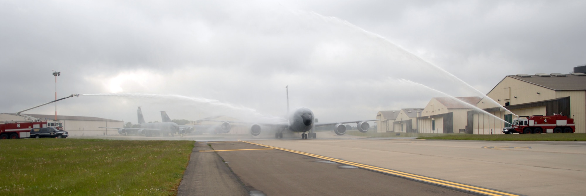 A KC-135 Stratotanker taxis through streams of water May 29, 2013, at RAF Mildenhall, England, during a fini flight for Col. Kyle Voigt, 100th Air Refueling Wing vice commander. The flight, a routine training refueling mission with the 31st Fighter Wing, commemorated Voigt’s time at RAF Mildenhall.  (U.S. Air Force photo by Airman 1st Class Dillon Johnston/Released)