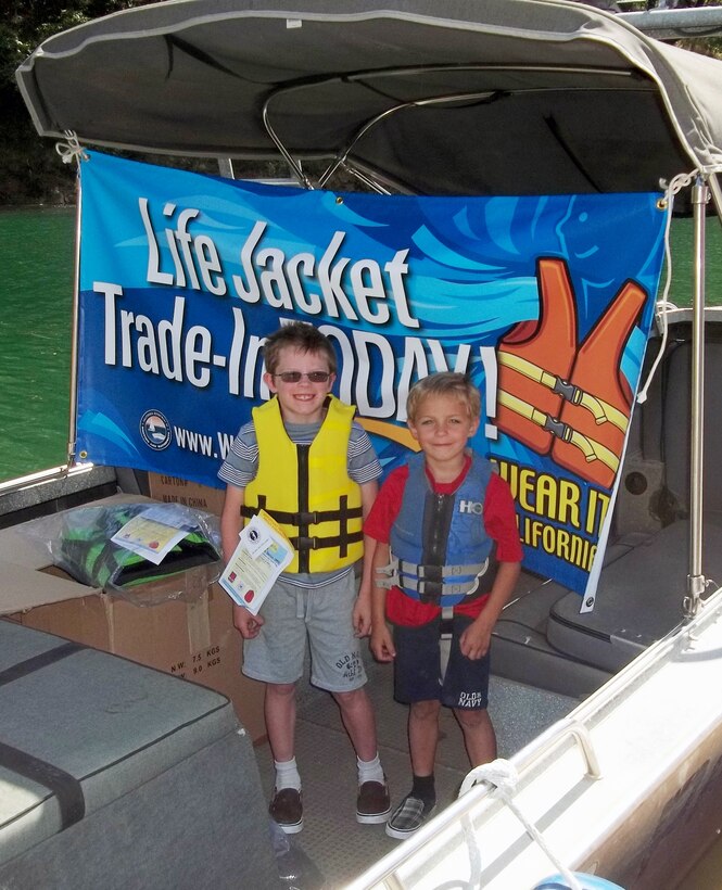 Youngsters beam with pride, wearing their new life jackets obtained in trade for used flotation devices during Life Jacket Trade-in Day, May 24, at Englebright Lake, the U.S. Army Corps of Engineers Sacramento District park near Smartville, Calif. The life jacket exchange was sponsored by the California Department of Boating and Waterways.