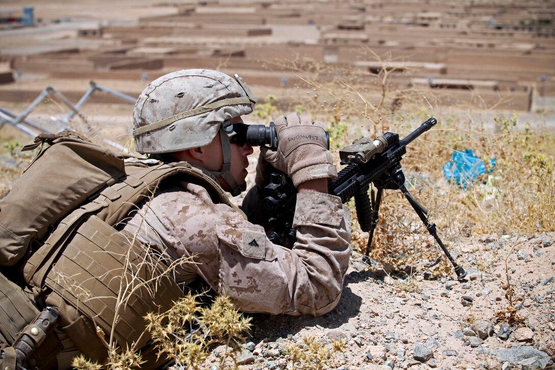 U.S. Marine Corps Lance Cpl. Robert Schrock scans for suspicious activity during a visit to an Afghan uniformed police post in the Now Zad district of Afghanistan's Helmand province, May 26, 2013. Schrock is assigned to Lima Company, 3rd Battalion, 4th Marine Regiment.