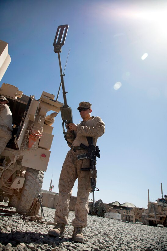 U.S. Marine Corps Lance Cpl. Clayton Dodson checks a compact metal detector before setting up a joint vehicle checkpoint with Afghan army soldiers in the Now Zad district of Afghanistan's Helmand province, May 27, 2013. Dodson, a machine gunner, is assigned to Combined Anti-Armor Team 1, 3rd Battalion, 4th Marine Regiment.
