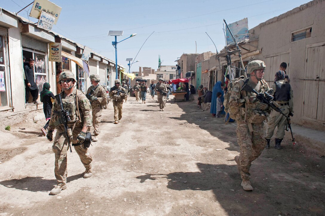 U.S., Afghan soldiers and Afghan police conduct a presence patrol and resupply mission through Baraki Rajan near Combat Outpost Baraki Barak in Afghanistan’s Logar province, May 22, 2013.