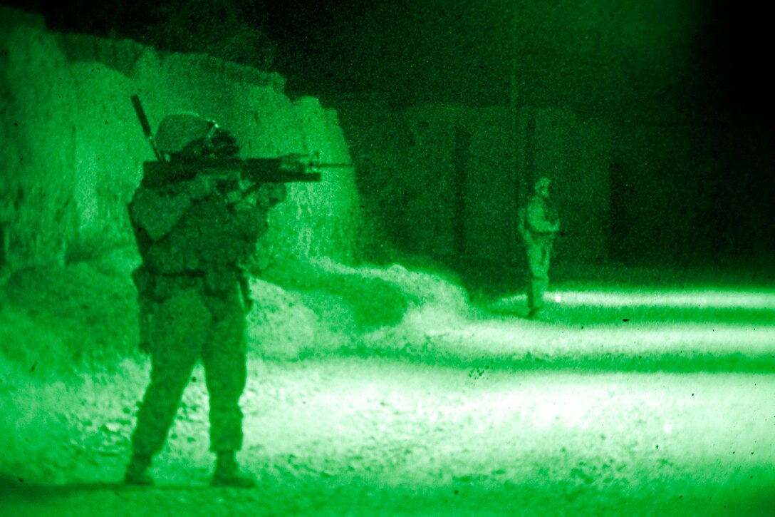 As seen through a night-vision device, U.S. Marine Corps Lance Cpl. Johnny Willis uses the optic lens on his weapon to scan the area during a night patrol near Combat Outpost Now Zad in the Now Zad district of Afghanistan's Helmand province, May 28, 2013. Willis is assigned to Lima Company, 3rd Battalion, 4th Marine Regiment.
