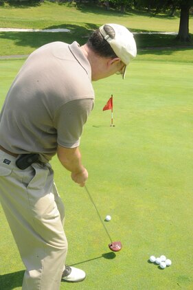 Mitch Hailstone, retired airman, takes practice putts at the Medal of Honor Golf Course aboard Marine Corps Base Quantico on May 10, 2013. Each of the 18 holes at the course is dedicated to a Medal of Honor recipient.