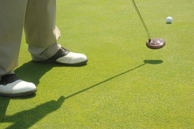 Mitch Hailstone, retired airman, putts a practice shot at the Medal of Honor Golf Course aboard Marine Corps Base Quantico on May 10, 2013. Golf experts suggest practicing between 30 minutes- one hour  a couple times a week in addition to playing several times a week for golfers to see definite improvement.