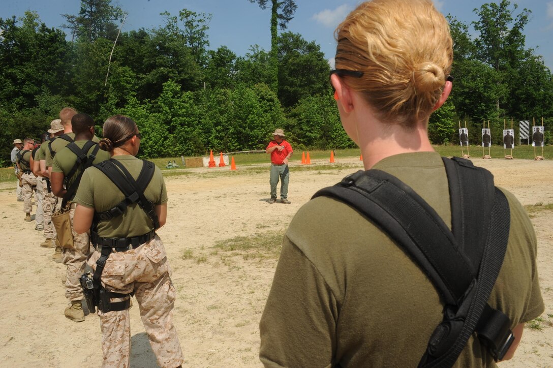 Marine Corps Base Quantico listen as Jeff Wood, an instructor, reviews procedures before a drill on May 22, 2013. The course is designed to make military law enforcement personnel more confident and efficient with their weapons.Students of the Advanced Law Enforcement Marksmanship Course aboard 