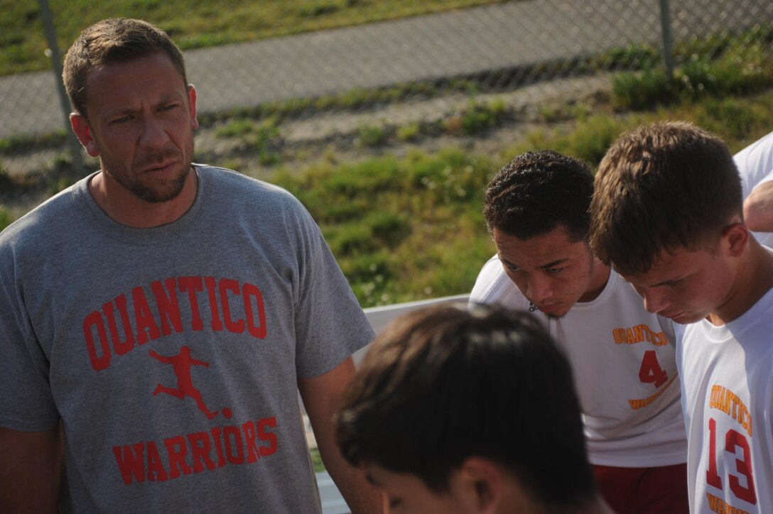 Robert Hume, Quantico varsity soccer coach, talks with players at Smith Lake Park in Stafford, on May 22, 2013. The Warriors played against Stafford Area Soccer Association to end the season.