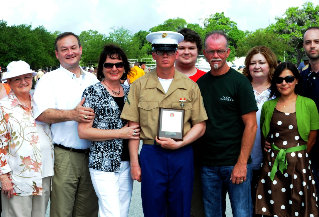 Private First Class Jeffrey D. Cowsert, honor graduate of platoon 2040, stands with his family after graduation aboard Parris Island, S.C., May 31, 2013. Cowsert is a native of Dacula, Ga., and was recruited from Recruiting Sub-Station Buford, Recruiting Station Atlanta by Staff Sgt. Ryan Lungerhausen. Cowsert will be able to enjoy some much deserved leave as he prepares for Marine Combat Training at Camp Geiger, N.C. (U.S. Marine Corps photo by Pfc. Stanley Cao)