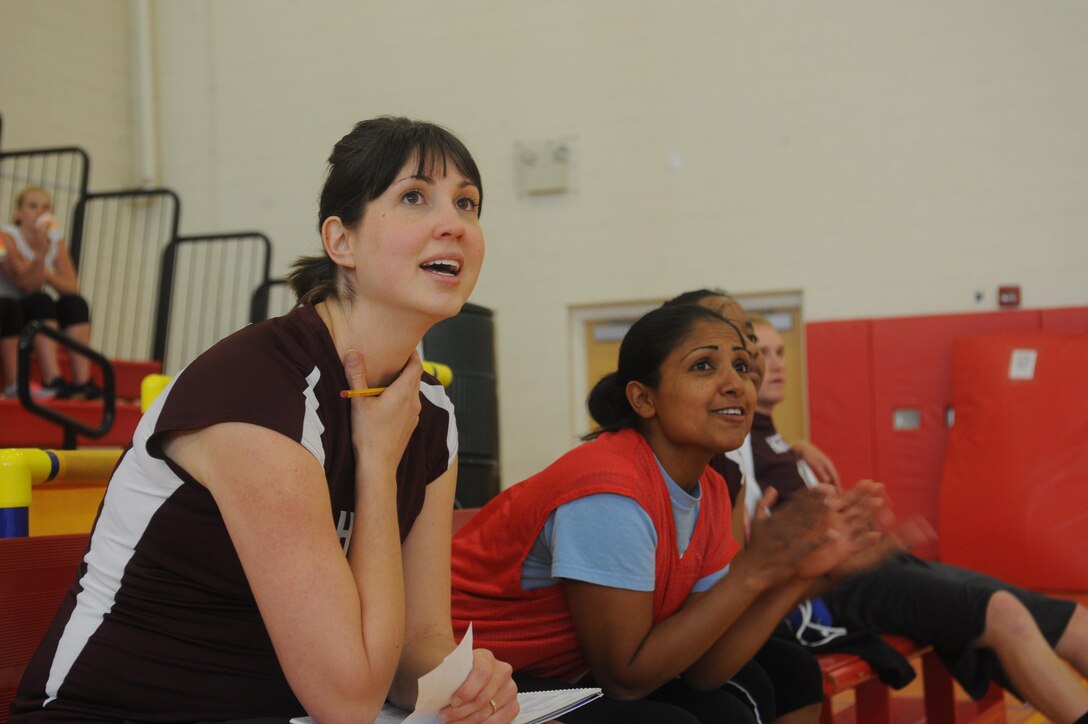 Members of the Headquarters and Service Bn. volleyball team watch as their teammates play against the Marine Helicopter Squadron 1 volleyball team at the Barber Physical Activities Center aboard Marine Corps Base Quantico on May 13, 2013. Both teams won games during the first night of intramural volleyball.
